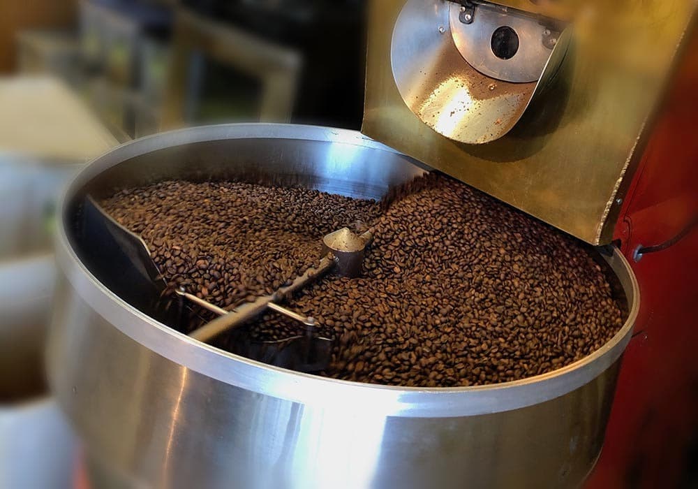 Fresh beans turning in the roaster drum at the Lakewood shop